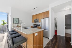 Modern kitchen with breakfast bar overlooking the open-concept living space.