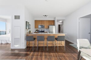 Open-concept kitchen with breakfast bar and contemporary finishes throughout.