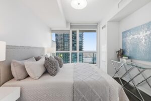 Spacious primary bedroom with contemporary décor and large windows.