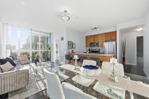 Open-concept living room overlooking the dining area and modern kitchen.