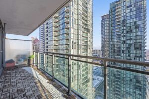 Spacious balcony with outdoor seating and sweeping views of Mississauga.