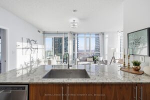 Contemporary kitchen with breakfast bar, granite countertops, and stainless steel appliances.
