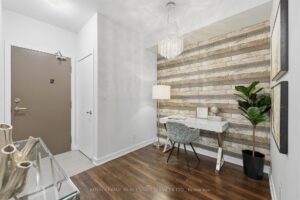 Front entry with modern finishes, hardwood flooring, and view toward the dining area.