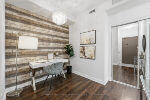 Dining area with modern lighting, feature wall, and open-concept layout.
