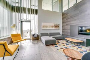 Elegant condominium lobby with soaring ceilings, fireplace, and designer furnishings.