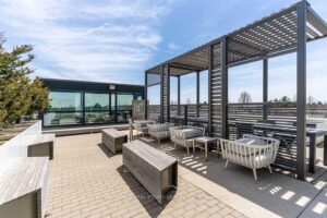 Rooftop terrace with pergolas, outdoor lounge seating, and skyline views.