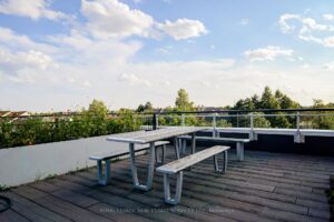 Rooftop terrace with picnic tables and expansive views of the surrounding area.
