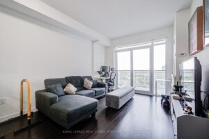Bright living room with floor-to-ceiling windows overlooking the private balcony.
