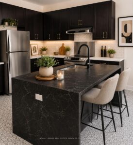 Spacious open-concept kitchen with large island, breakfast area, and dark cabinetry.