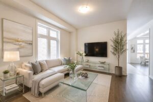Bright formal living room with oversized windows, hardwood flooring, and contemporary finishes.