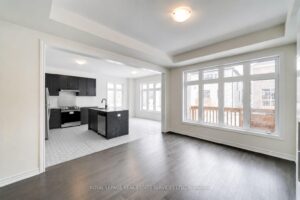 Spacious open-concept kitchen with large island, breakfast area, and dark cabinetry.