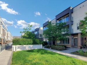 Landscaped courtyard surrounded by contemporary townhomes in a desirable community.