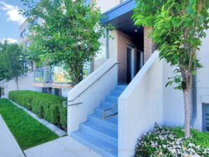 Welcoming front entrance with private staircase, landscaped walkway, and modern exterior finishes.