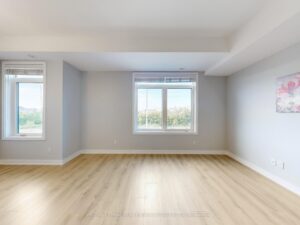 Spacious living area featuring oversized windows, neutral décor, and open-concept design.