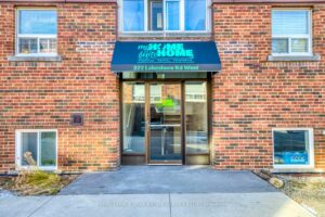 Main entrance to the residential building at 322 Lakeshore Road West with secure access.
