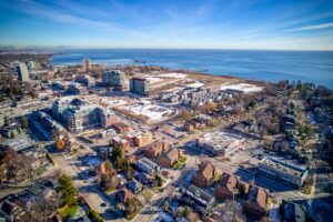 Aerial view of Port Credit GO Transit corridor with Lake Ontario and Toronto skyline in the distance.