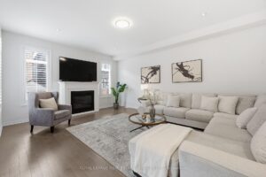 Bright family room with large windows, modern furnishings, and open-concept layout.