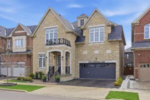 Elegant two-storey brick home with double garage and landscaped front yard.