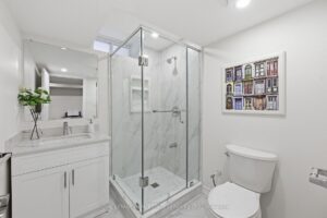 Spa-inspired ensuite bathroom with glass shower, double vanity, and contemporary finishes.