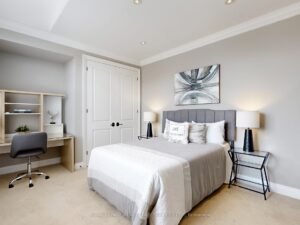 Bright secondary bedroom with vaulted ceiling, large closet, and neutral décor.