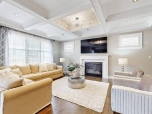 Spacious family room with fireplace, contemporary furnishings, and abundant natural light.