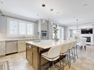 Gourmet kitchen with centre island, quartz countertops, and breakfast bar seating.