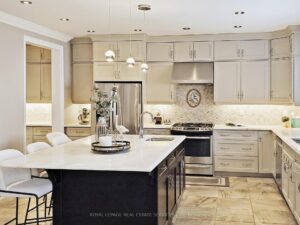 Modern chef's kitchen featuring custom cabinetry, quartz countertops, and stainless steel appliances.