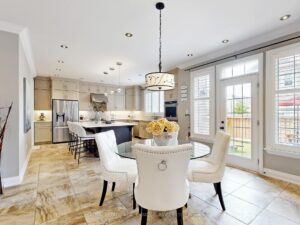 Bright breakfast area with large windows overlooking the backyard and open-concept kitchen.