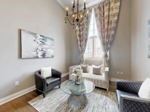 Cozy sitting area with elegant drapery and large windows filled with natural light.