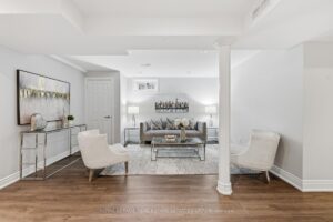 Finished basement recreation area with comfortable seating and open-concept layout.