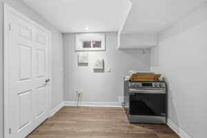 Lower-level utility and storage room with above-grade window.
