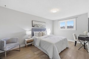Spacious primary bedroom with sitting area, large window, and modern finishes.