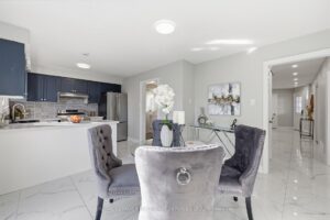 Breakfast area beside the kitchen with polished flooring and open layout.
