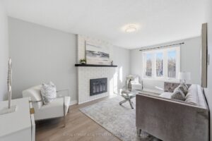 Family room with fireplace, large window, and comfortable seating area.