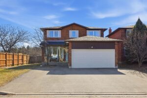Front elevation of the two-storey brick home with double garage and driveway.
