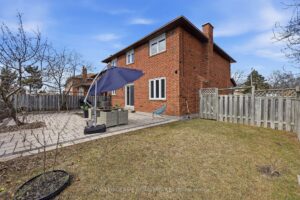 Backyard patio with stone pavers overlooking the fully fenced yard.