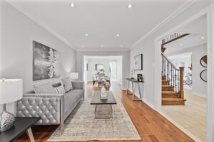 Spacious living room with open sightlines to the foyer and dining area.