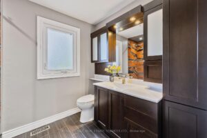 Bathroom with dark wood vanity, tub-shower combination, and modern tile.