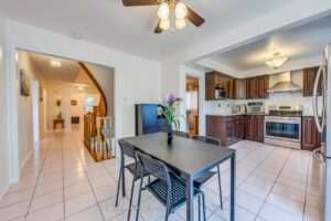 Open-concept kitchen and breakfast area with view toward the staircase and main living spaces.