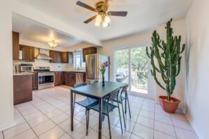 Open-concept kitchen and breakfast area with sliding doors overlooking the backyard.