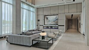 Bright resident lounge with floor-to-ceiling windows and seating area.