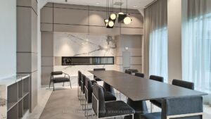 Stylish conference room with long table, kitchenette, and floor-to-ceiling windows.