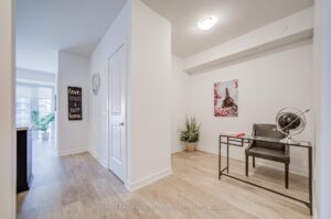 Condo entry foyer with double closet, light flooring, and neutral finishes.