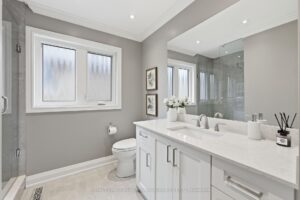 Luxury ensuite bathroom with double vanity, freestanding tub, and oversized glass shower.