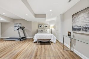Lower-level recreation room with exercise area and spacious open-concept layout.