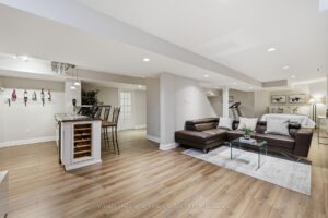 Finished basement featuring a recreation room, wet bar with wine storage, and comfortable lounge area.