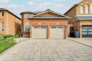 Front elevation of the Mattamy-built two-storey home with double garage, interlock driveway, and landscaped front yard.