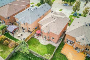 Aerial view of the fully fenced backyard and surrounding homes.