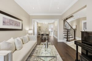 Elegant living room with hardwood flooring and view through to the formal dining room and staircase.
