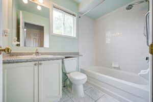 Four-piece bathroom with vanity, bathtub, and shower curtain bar.